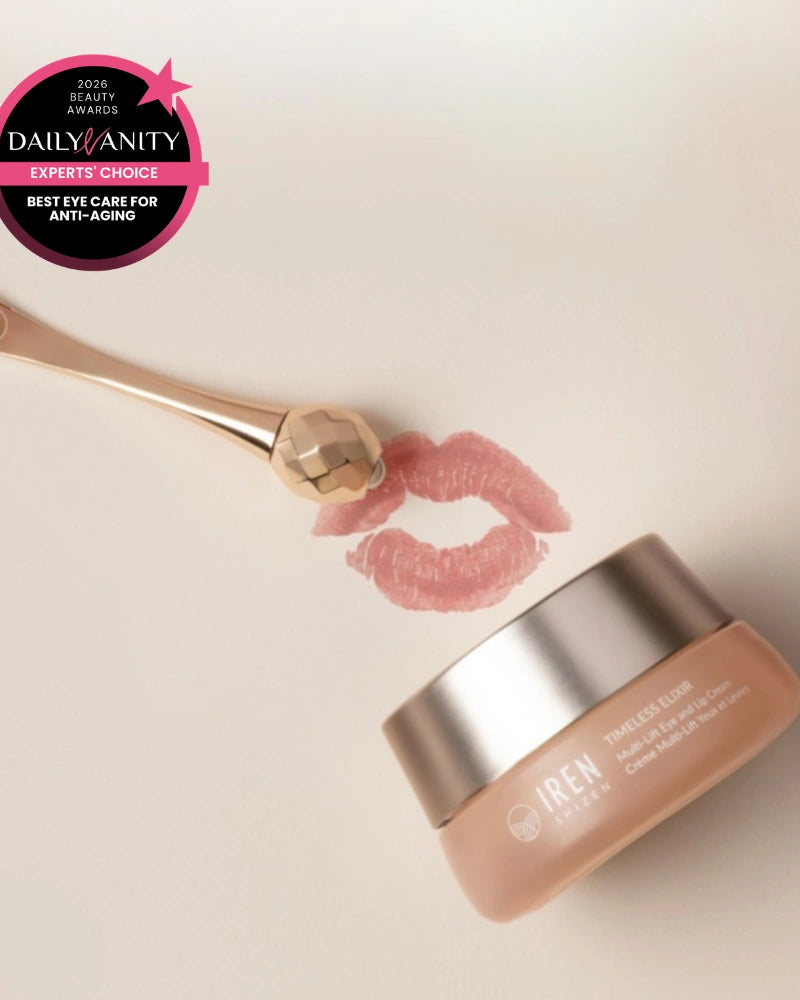 A jar of IREN Shizen TIMELESS ELIXIR Multi-Lift Eye and Lip Cream sits with a gold facial roller and lipstick print on a light surface. An award badge highlights it as "Best Eye Care for Anti-Aging" and a top dark circles treatment.