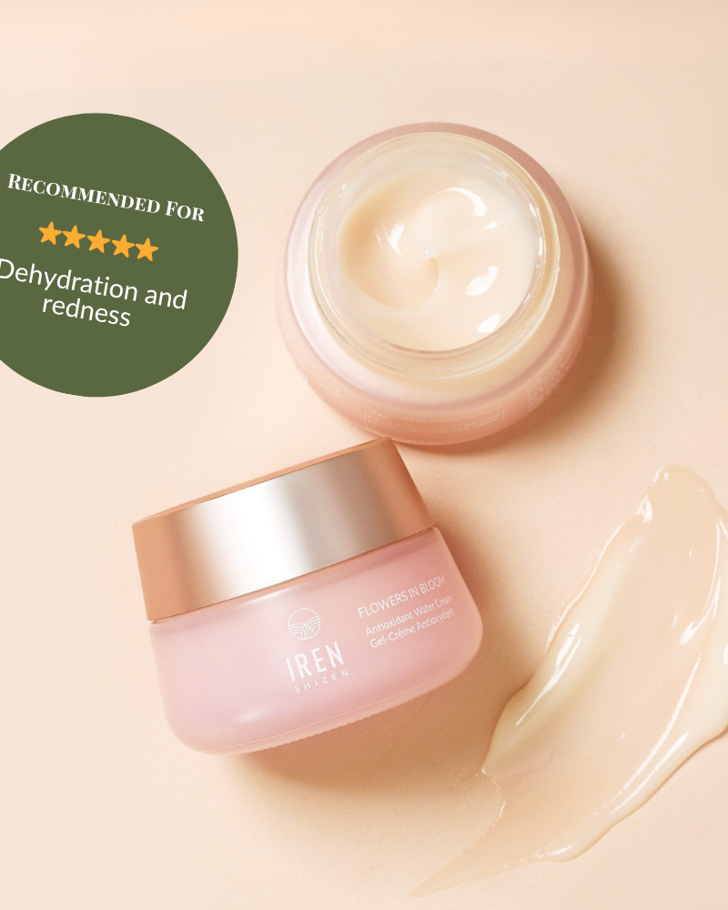 An open jar of IREN Shizen FLOWERS IN BLOOM Antioxidant Water Cream sits beside a dab of cream. The label notes this natural-origin skincare is ideal for dehydration and redness.