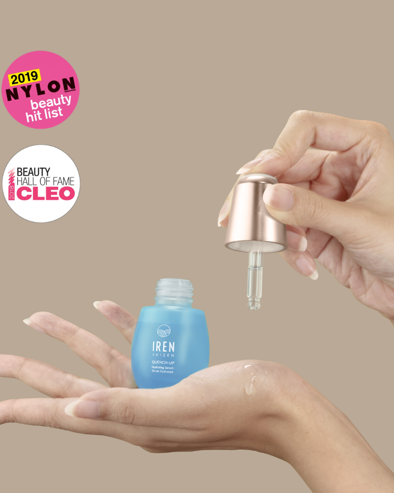 A hand dispenses QUENCH-UP Hydrating Serum from an IREN Shizen dropper bottle onto another hand. Nylon Beauty Hit List 2019 and Cleo Beauty Hall of Fame badges spotlight this plump skin hero.