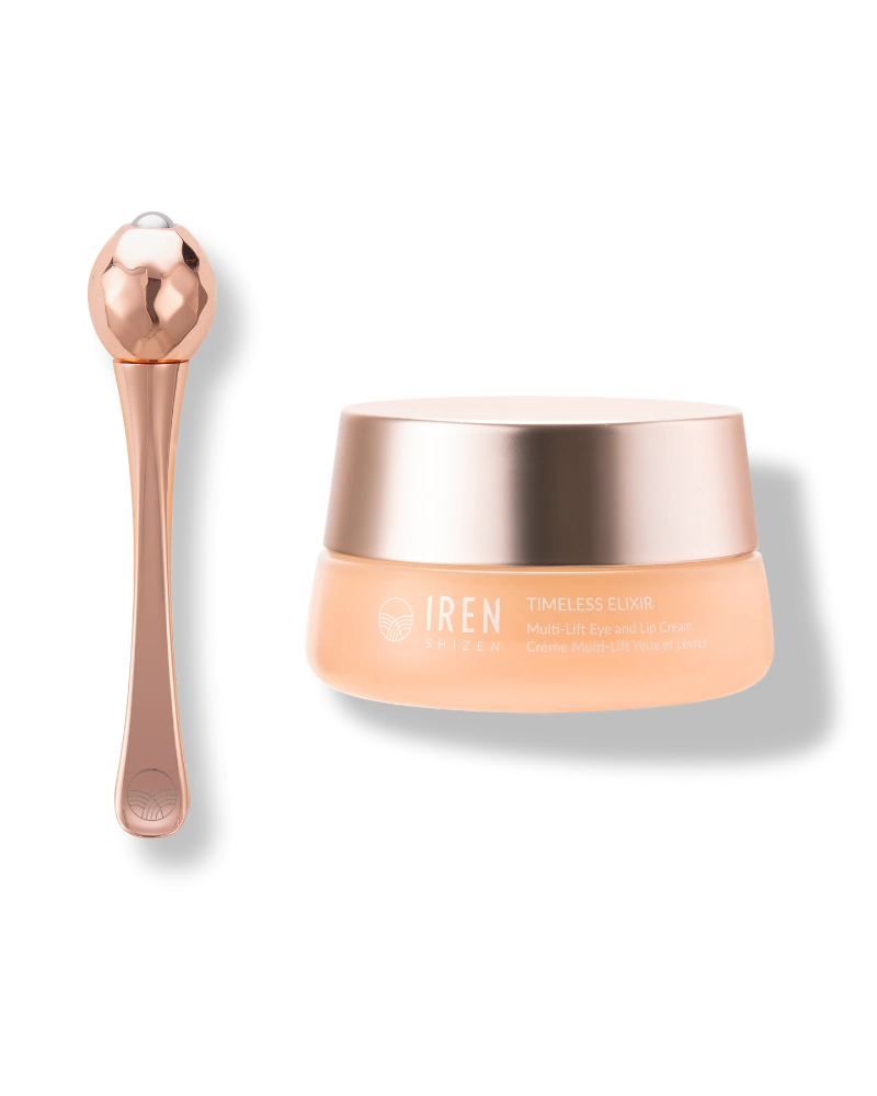 A rose gold facial massager sits beside a jar of IREN Shizen TIMELESS ELIXIR Multi-Lift Eye and Lip Cream, an anti-aging solution for dark circles, beautifully displayed on a light background.
