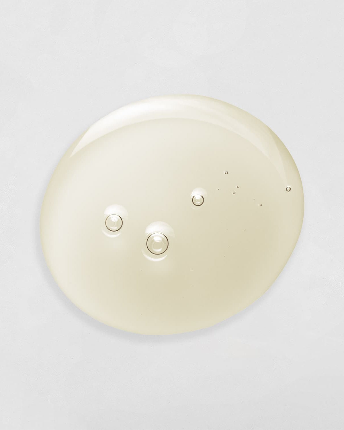 A white DROP OF DEW Moisturizing Facial Oil circle on a white background from the brand IREN Shizen, known for its customised Japanese skincare products. all-groups