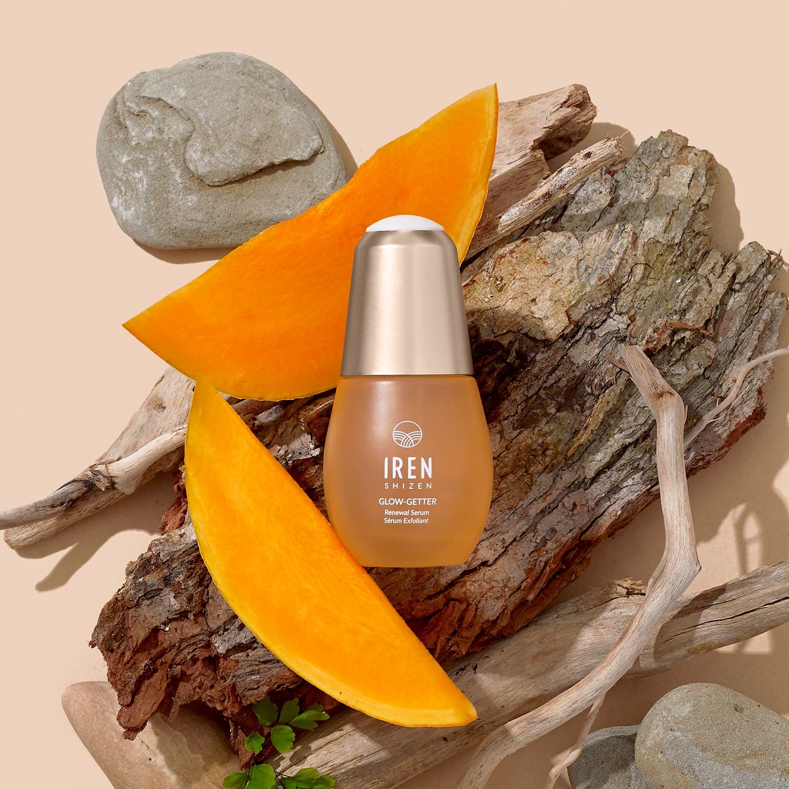 A bottle of customised Japanese skincare Glow-Getter Renewal Serum by IREN Shizen next to a slice of orange. #all-groups