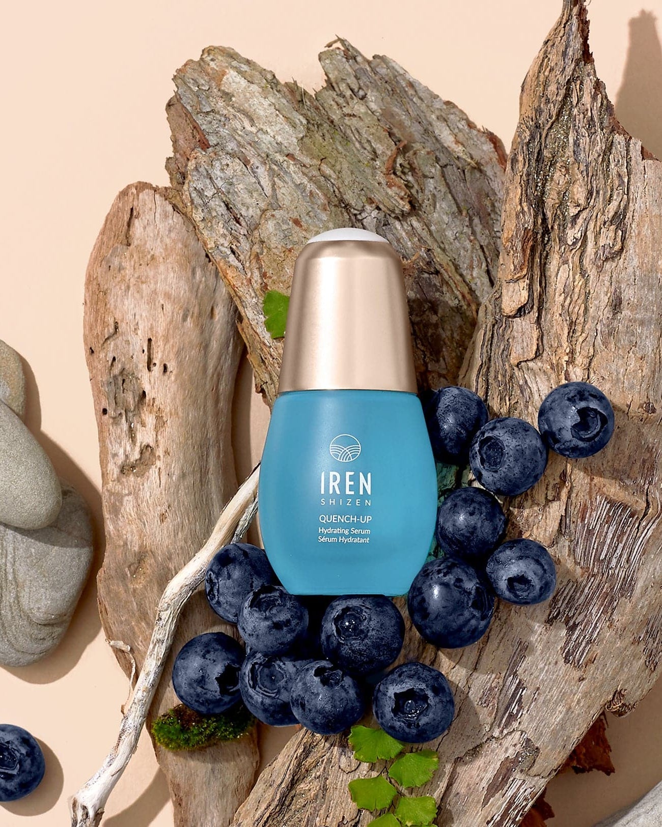 A bottle of customised QUENCH-UP Hydrating Serum by IREN Shizen on a piece of wood. #all-groups