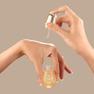 A woman's hand is holding a customised bottle of IREN Shizen GLOW-GETTER Renewal Serum. #all-groups