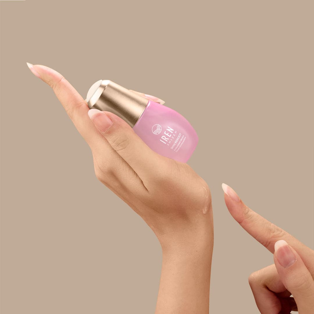 A woman's hand holding a bottle of Japanese customised skincare by IREN Shizen. #all-groups