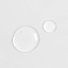 Two Japanese QUENCH-UP Hydrating Serum drops on a white surface. #all-groups