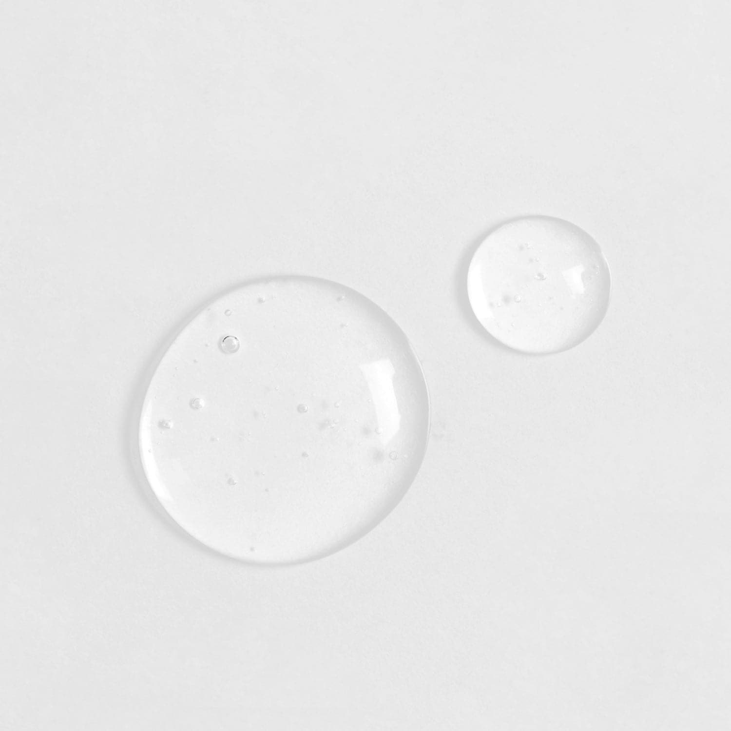 Two Japanese QUENCH-UP Hydrating Serum drops on a white surface. #all-groups