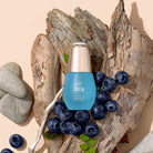 A bottle of customised QUENCH-UP Hydrating Serum by IREN Shizen on a piece of wood. #all-groups