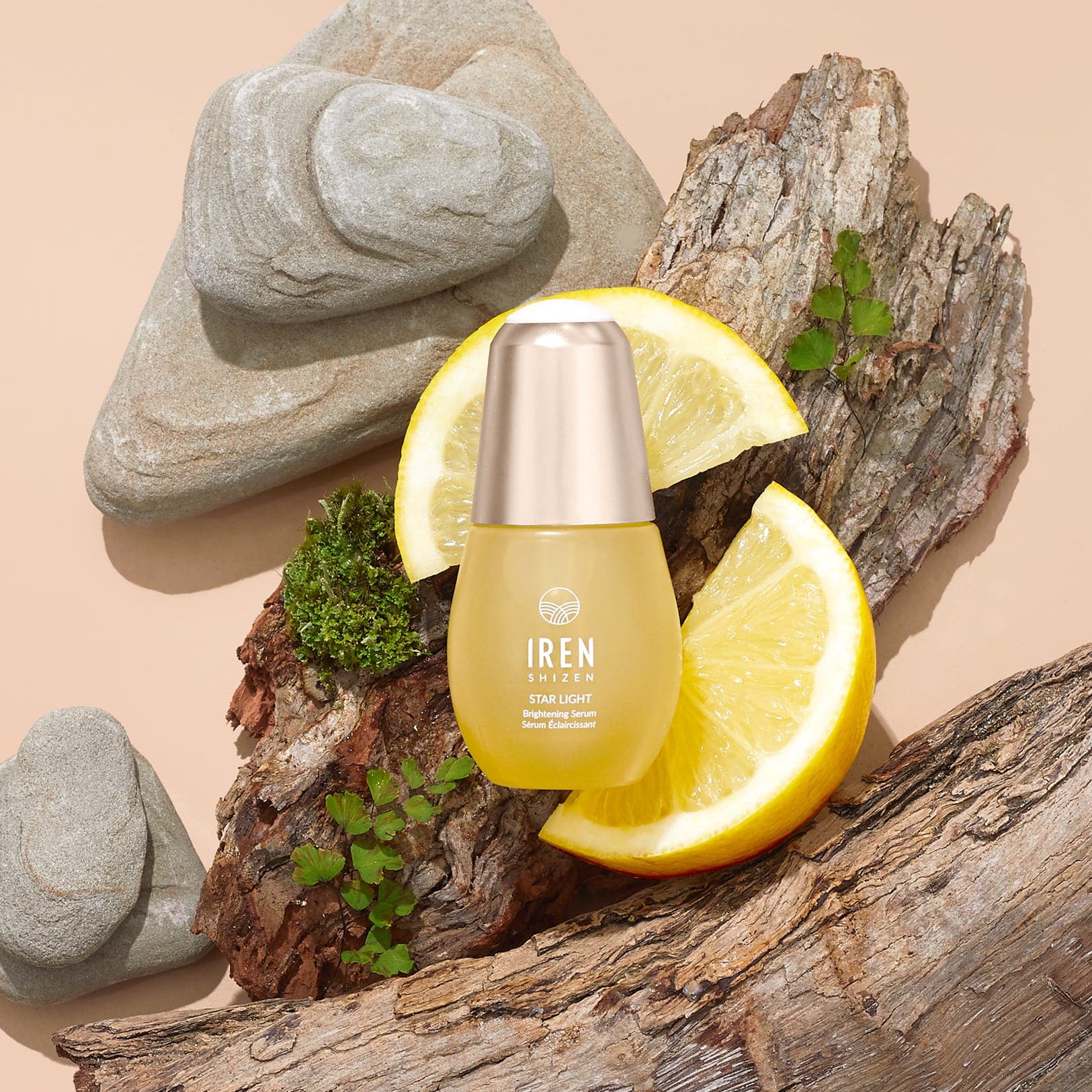 A bottle of customised STAR LIGHT Brightening Serum by IREN Shizen on a rock. #all-groups